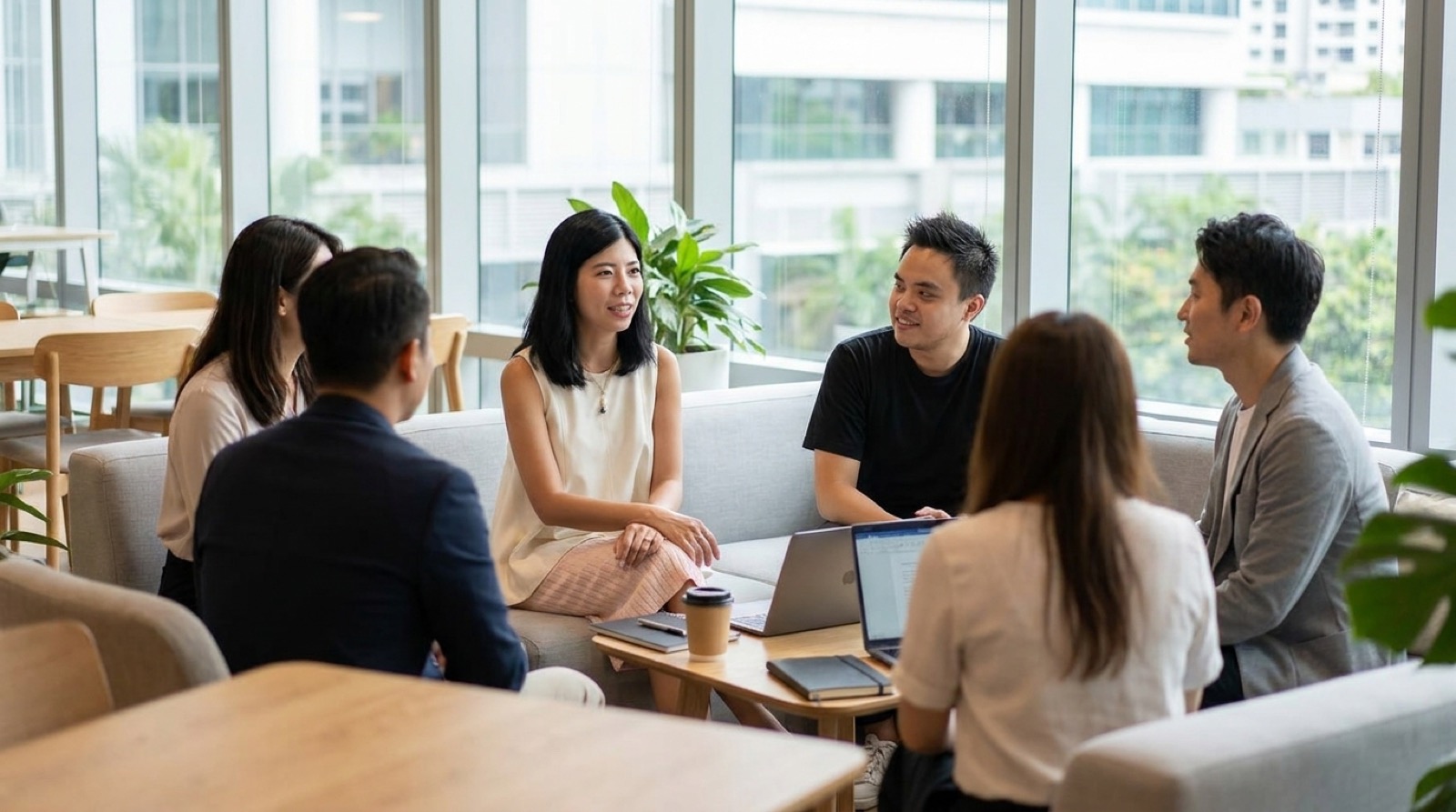 Novastacks senior operators in a casual office lounge, discussing a client's AI search strategy